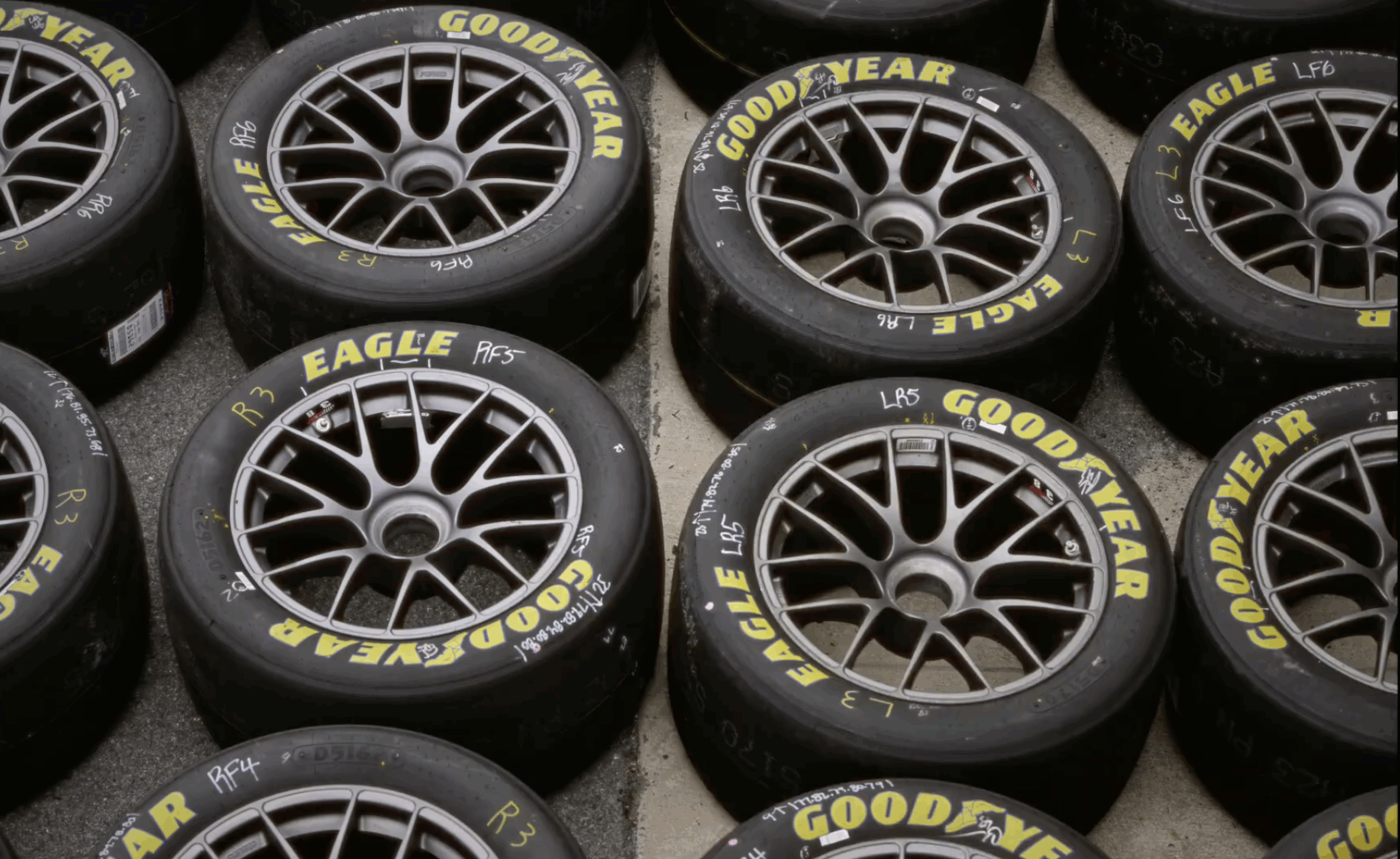 Several Good Year branded tires laying flat on concrete