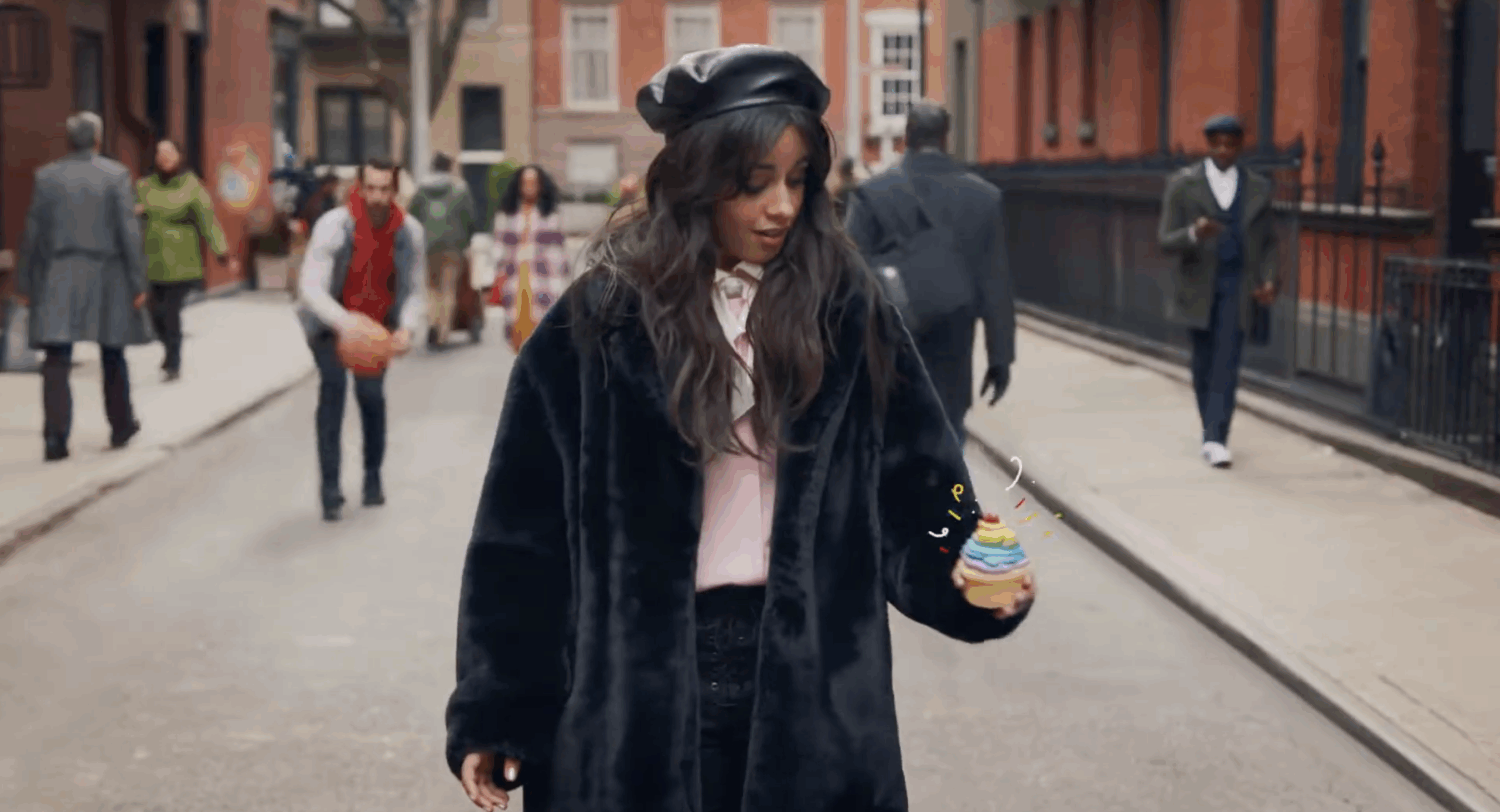 Screenshot of Lots O' Spots campaign with woman standing on a city block looking at cupcake in left hand
