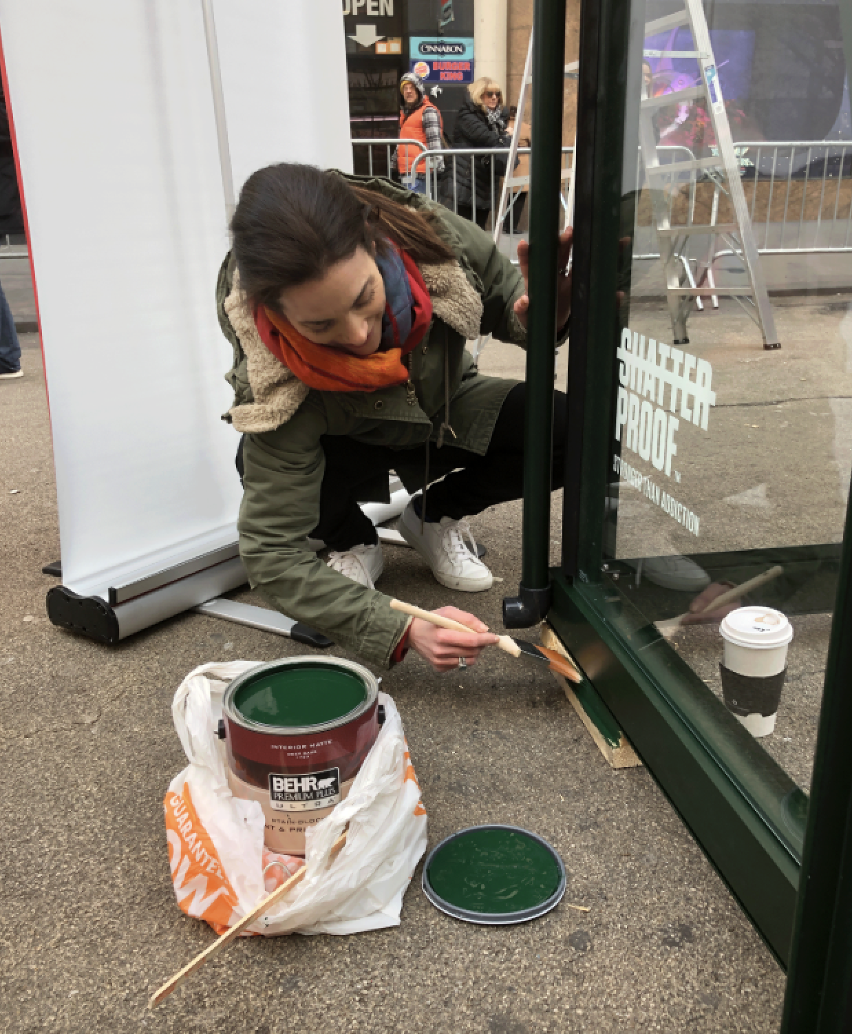 Photo of Deb painting the exterior of an installation